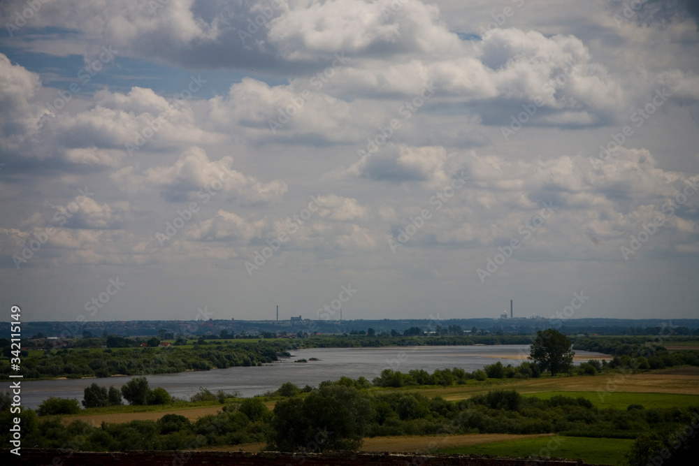  summer landscape from Poland with the flowing Vistula river on a warm summer day with blue sky and clouds