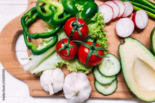 Still life of fresh organic vegetables on wooden plate, selectiv photo