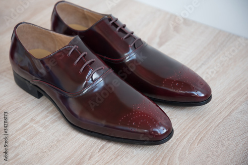 A pair of good beautiful and expensive men's shoes. The concept of success and style. Maroon. © dewessa