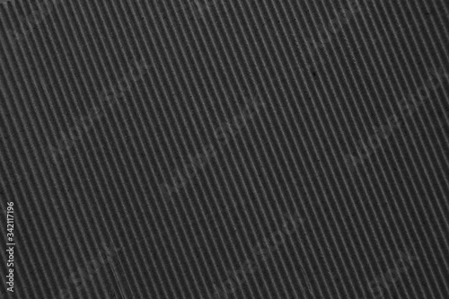 Dark gray background of corrugated cardboard. Diagonal stripes. Template for website, banner, poster, wallpaper.