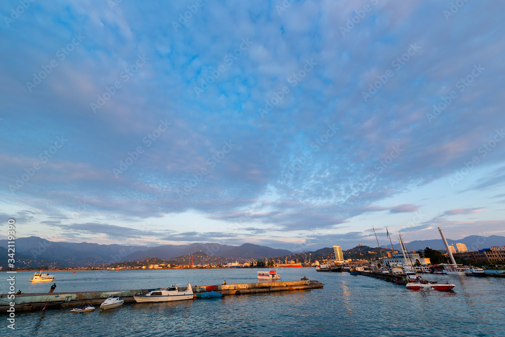 Beautiful sunset and small ships in Batumi sea port