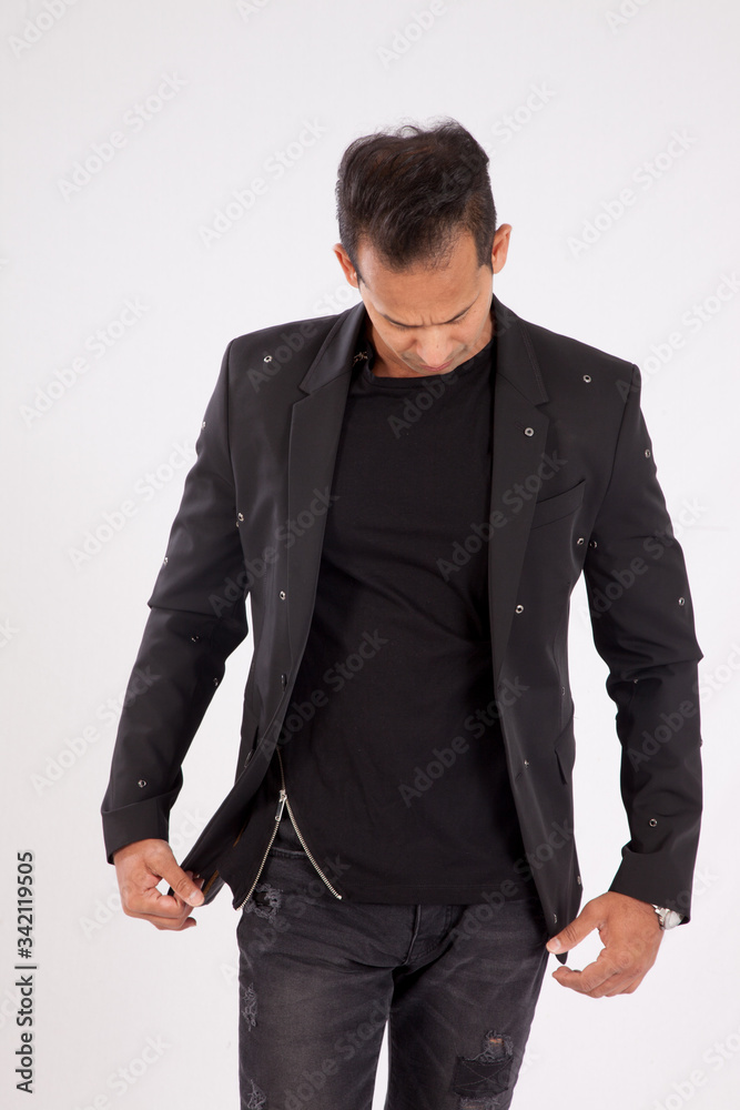 Handsome man in black shirt and jacket looking thoughtful Handsome man in black shirt and jacket looking thoughtful