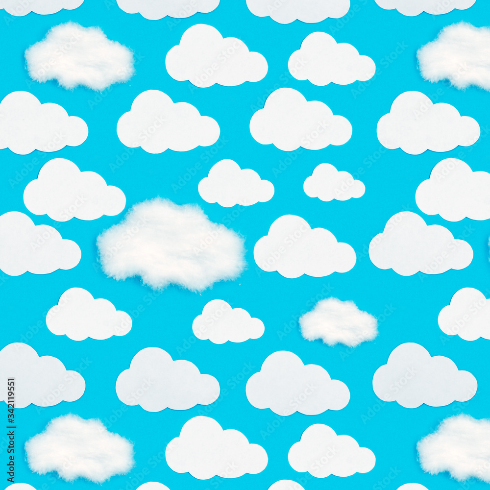Pattern of paper clouds on a blue background. Pattern of paper clouds on a blue background.