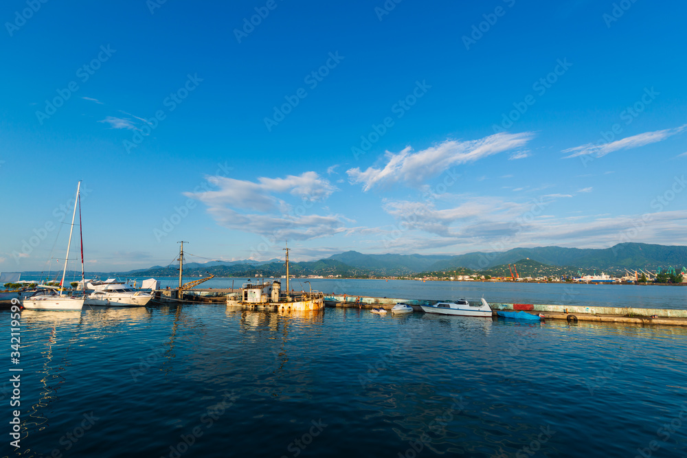 Beautiful sunset and small ships in Batumi sea port