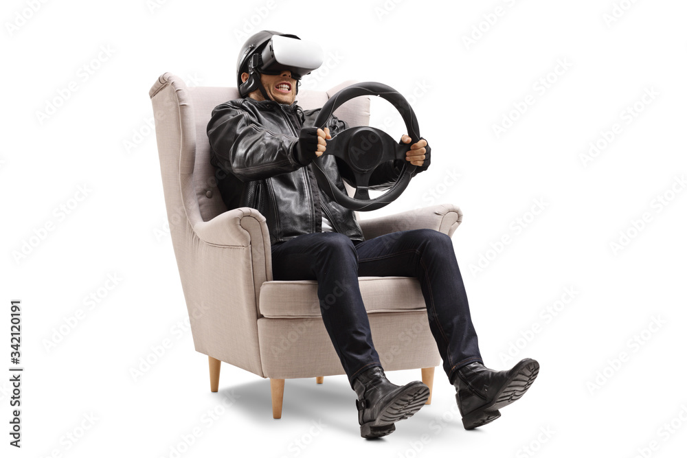 Man sitting in an armchair and riding with a wheel on a virtual reality set