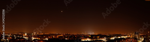 Light pollution over the city of Gdansk - Moon and Venus flushed by city lights. © Fredrixxon