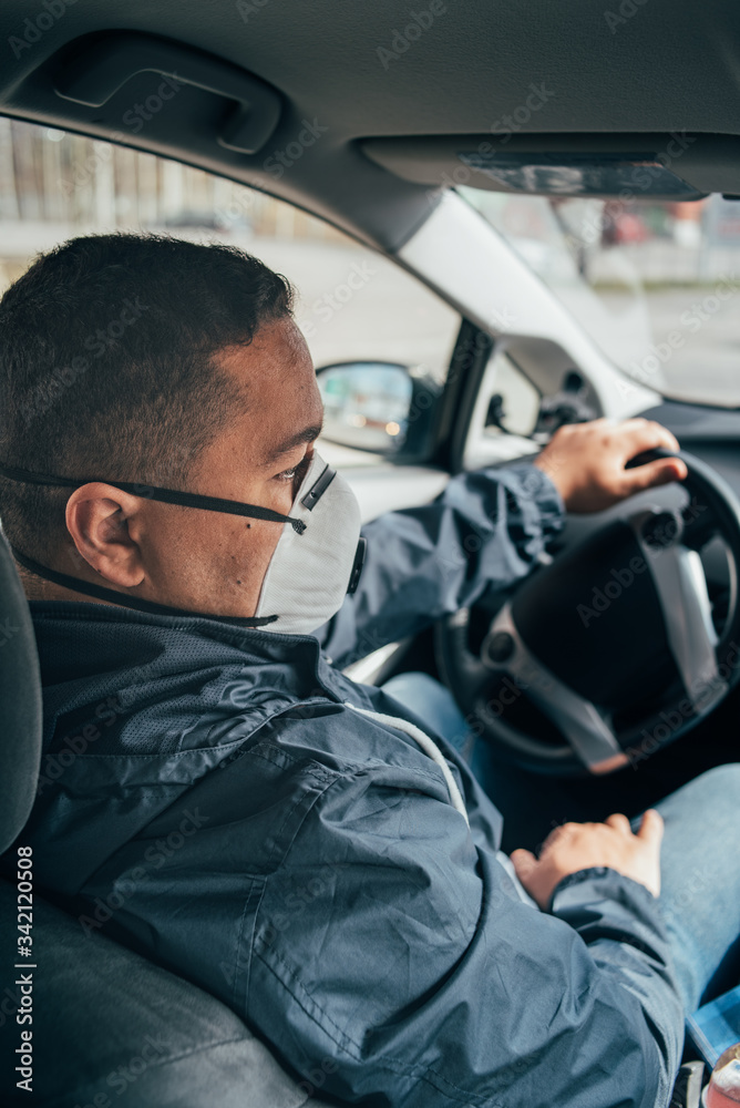 young hispanic taxi driver wearing a protective mask . quarantine. covid 19. young hispanic taxi driver wearing a protective mask . quarantine. covid 19.