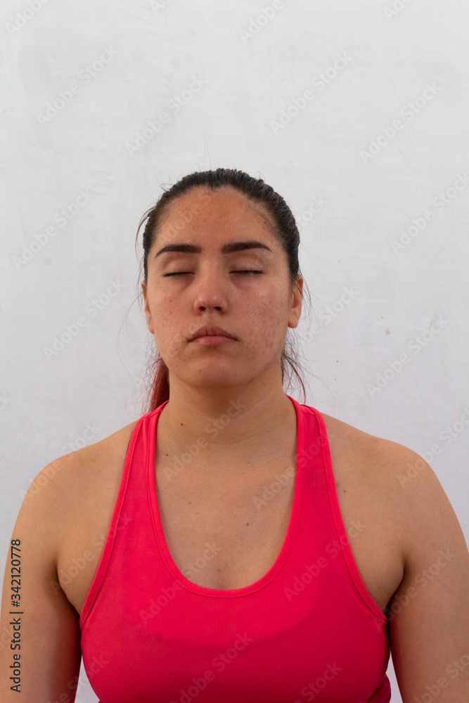 young hispanic woman meditating relaxed with lotus flower yoga position in room wearing sportswear young hispanic woman meditating relaxed with lotus flower yoga position in room wearing sportswear