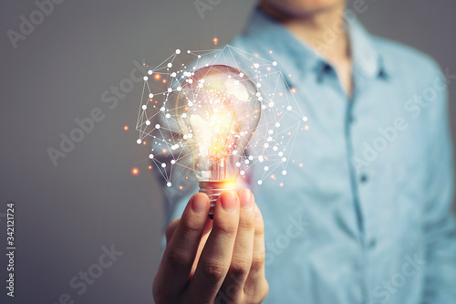 Man holding light bulbs, ideas of new ideas with innovative technology and creativity. concept creativity with bulbs that shine glitter.