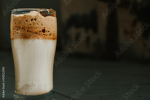 Closeup shot of Dalgona coffee in glass on a table