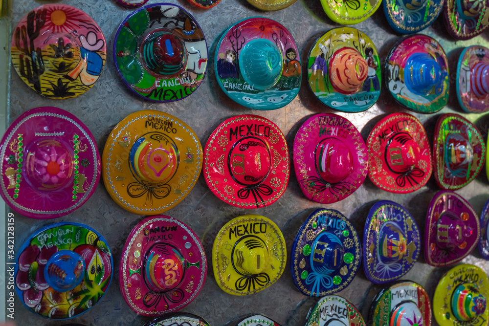 Souvenir magnet display in Cancun Local Fair. Colorful sombreros are inexpensive and easy to bring back home for family and friends. Cure memories made by local Mayan people