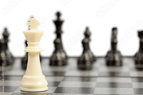 Chess pieces on the chessboard on white background. Closeup of some chess figures