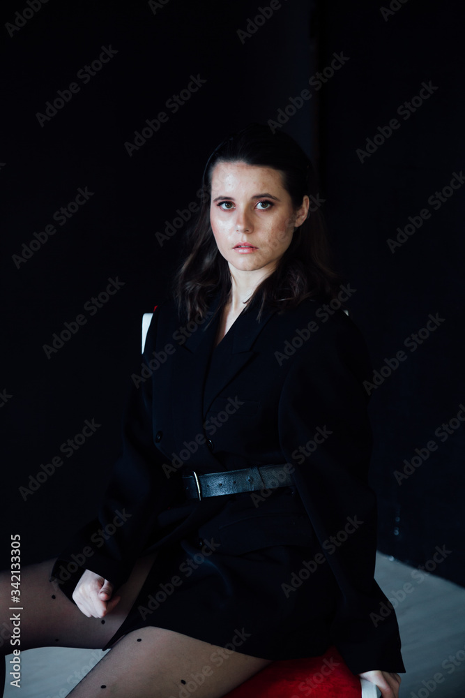 Portrait of a beautiful young fashionable brunette brunette woman in a business suit Portrait of a beautiful young fashionable brunette brunette woman in a business suit