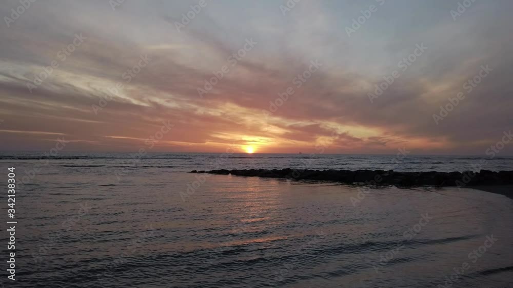Awesome sunset at beach zoom in to horizon with beautiful sunlight and dramatic cloudy sky Awesome sunset at beach zoom in to horizon with beautiful sunlight and dramatic cloudy sky
