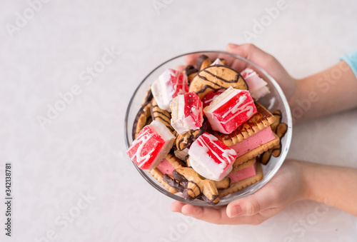 bowl of sweet dessert in your hands. Cookies and marmalade on a white background