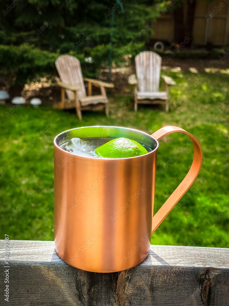 cold beverage with limes in copper mug cold beverage with limes in copper mug