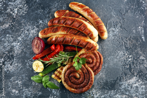 Assorted delicious grilled meat with vegetable on a barbecue with grilled sausages and vegetables on table
