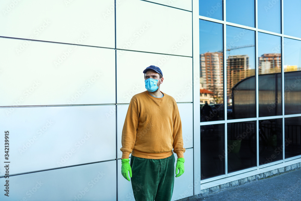 man in medical mask and gloves near shopping center looking away, safety shopping man in medical mask and gloves near shopping center looking away, safety shopping