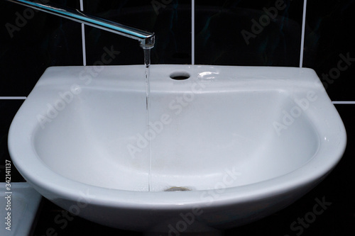 Tap water flows into the sink