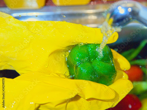 Washing the vegetables under running tap water during COVID-19 coronavirus outbreak.