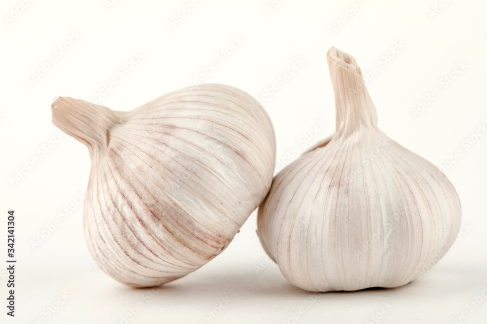 two raw cloves of garlic isolated on white background two raw cloves of garlic isolated on white background