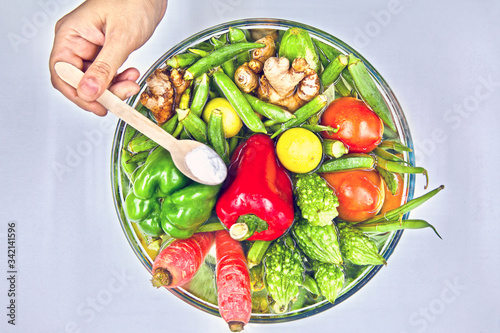 Washing and soaking fresh market vegetables, in a water and baking soda solution to safely remove pesticide and other chemical residues.