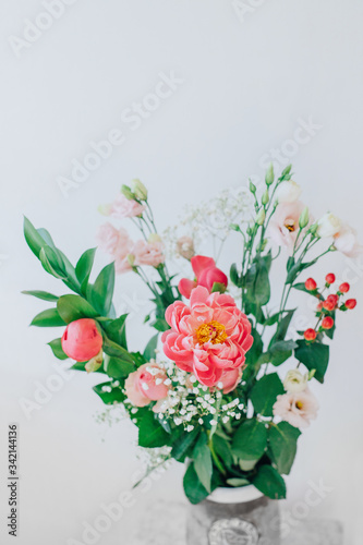 Bouquet of beautiful peonies in a vase on the table. Lovely flowers. © dariamyronets