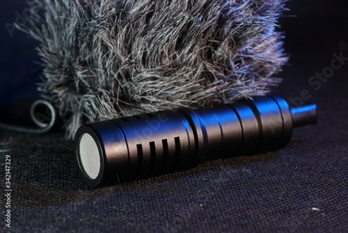 Modern microphone against dark background