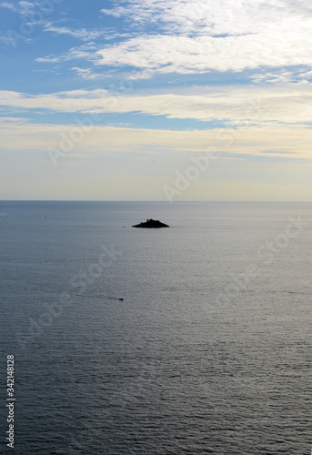 silhouette of very small island in the middle of the ocean