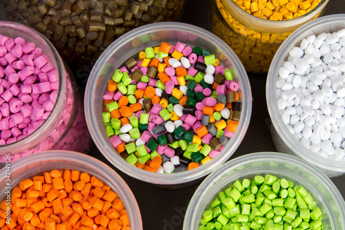 Plastic pellets. Dyes for plastic, polypropylene, polyethylene. Plastic granules in a measuring container and test tubes in the laboratory. photo