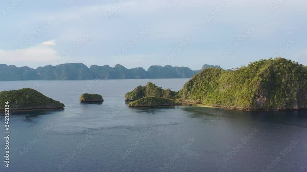 Idyllic tropical islands, surrounded by coral, are found in Raja Ampat, Indonesia. This region is known as the heart of marine biodiversity and is a popular destination for divers and snorkelers. Idyllic tropical islands, surrounded by coral, are found in Raja Ampat, Indonesia. This region is known as the heart of marine biodiversity and is a popular destination for divers and snorkelers.