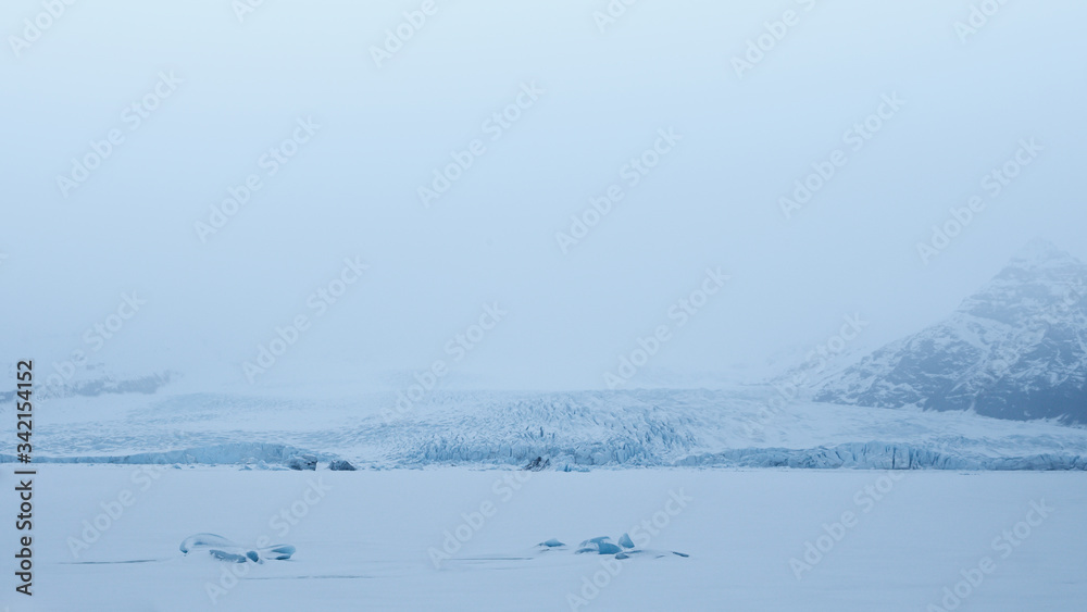 Frozen Fjallsárlón with blue glacier in background, Vatnajökull national park Frozen Fjallsárlón with blue glacier in background, Vatnajökull national park