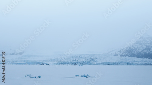 Frozen Fjallsárlón with blue glacier in background, Vatnajökull national park