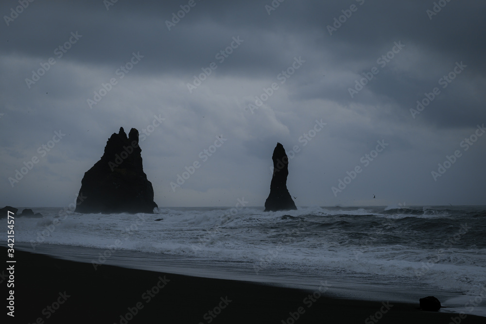 Reynisfjara black sand beach & Reynisdrangar in dark and moody weather, Iceland