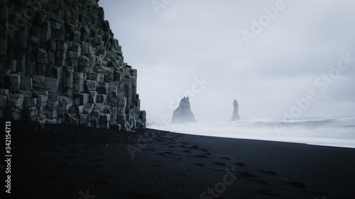 Reynisfjara black sand beach & Reynisdrangar in dark and moody weather, Iceland