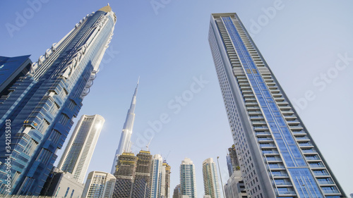 Tall and modern skyscrapers of Dubai on a sunny day. © Довидович Михаил