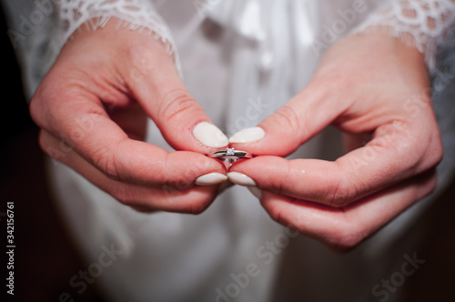bride holding gold wedding ring in the hands