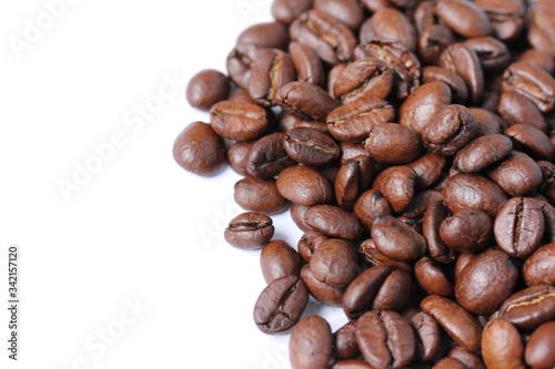 Dark roasted Arabica coffee beans on a white background