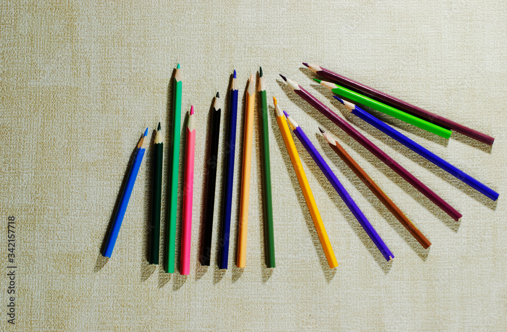 a few colored pencils on light background. a few colored pencils on light background.