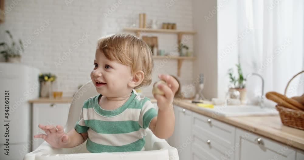 Cute little baby left alone in kitchen, messing with dough with face covered with flour. Child playing with food and positively smiling close up 4k Cute little baby left alone in kitchen, messing with dough with face covered with flour. Child playing with food and positively smiling close up 4k