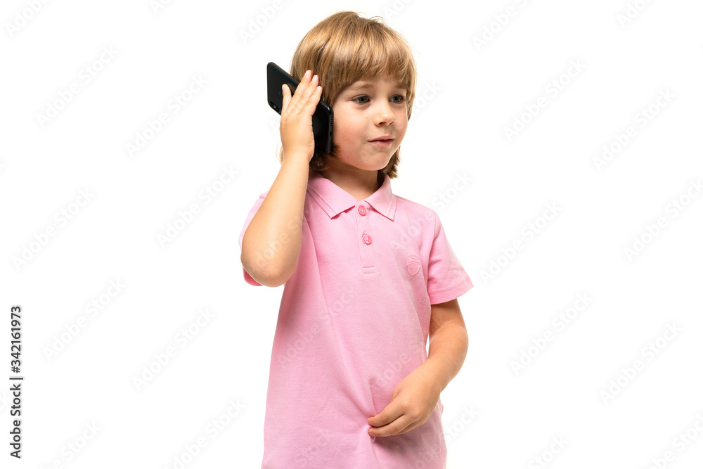 Caucasian teeanger boy holds a phone isolated on white background Caucasian teeanger boy holds a phone isolated on white background