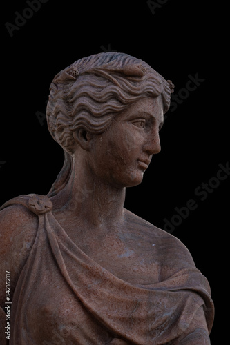 Clay head of an ancient Greek goddess isolated on black background