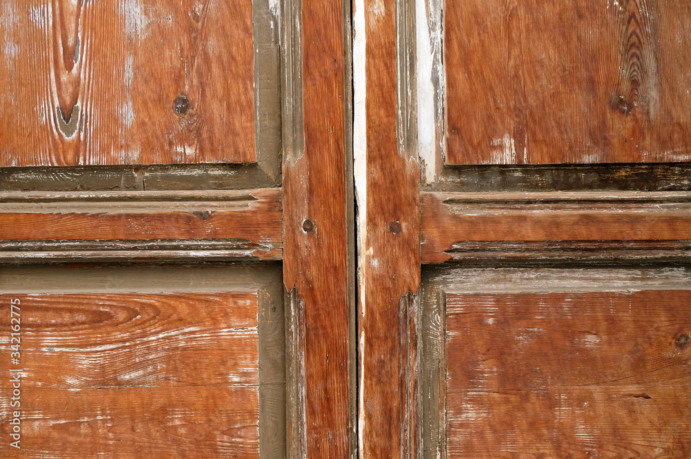 Old wooden door with weathered and aged timber texture.