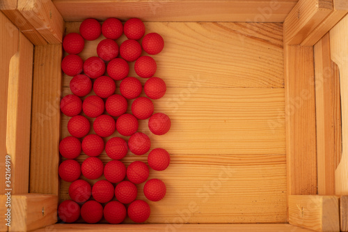balls arranged in a wooden box