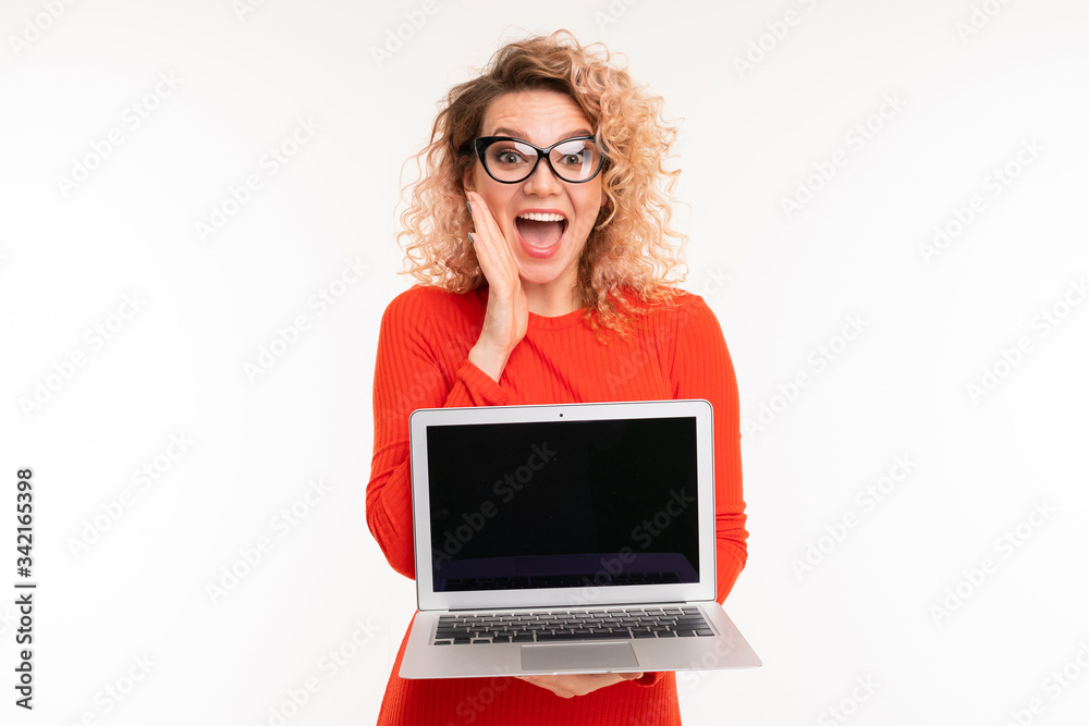 attractive curly girl holding a laptop with mockup in her hands on a white background attractive curly girl holding a laptop with mockup in her hands on a white background