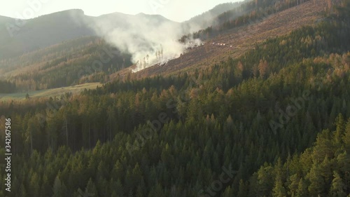 4k aerial drone shot - extinguishing a forrest fire during sunset - nice color cinematic footage