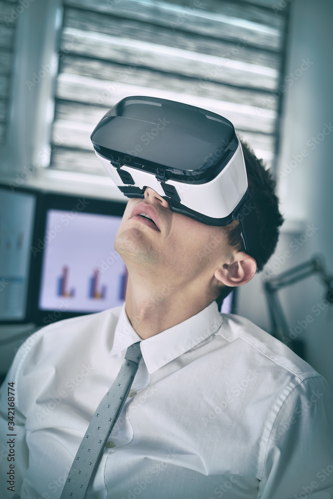 Businessman With VR Glasses Working In Office. Businessman With VR Glasses Working In Office.