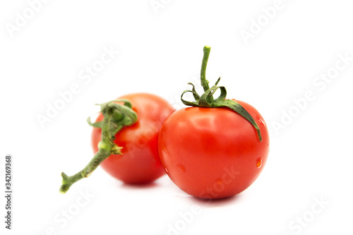 Two ripe fresh organic tomatoes with dew drops isolated on white background. 