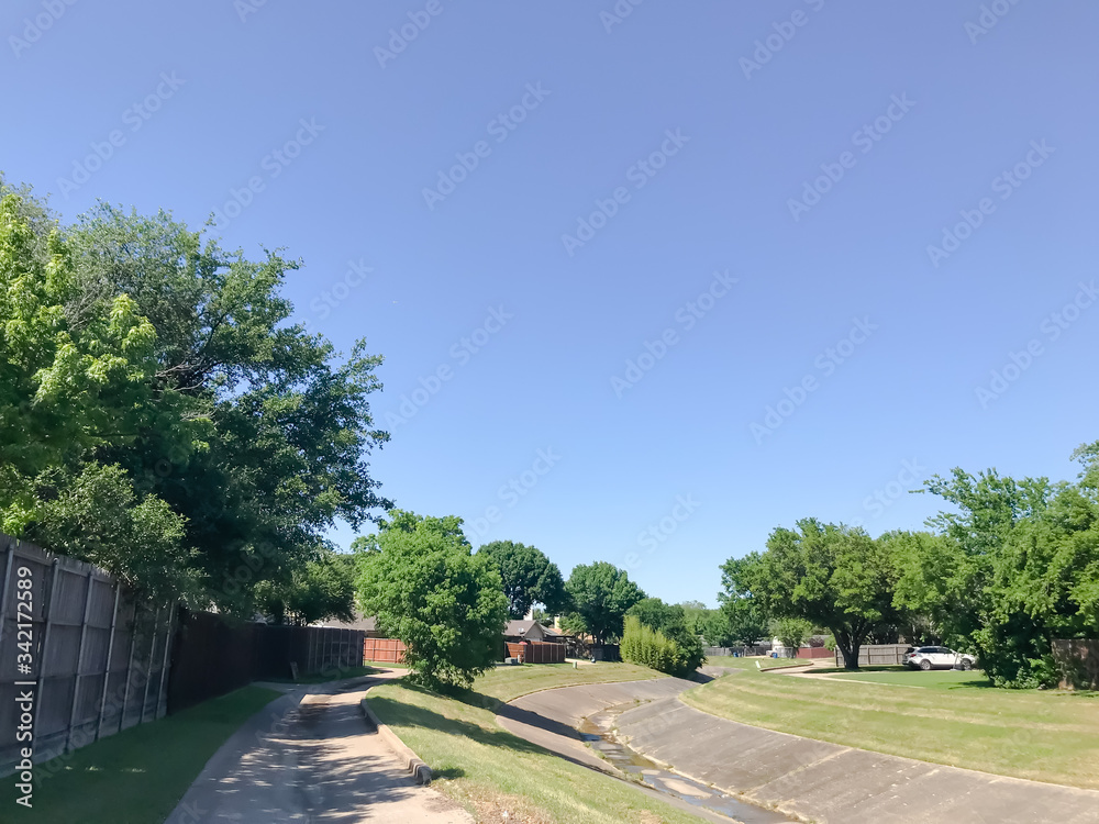 Typical residential neighborhood with an open air drainage canal in Dallas, Texas, USA