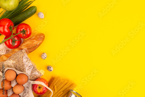 Food packaging on yellow background. Quarantine food delivery home. Flatlay banner with copyspace.